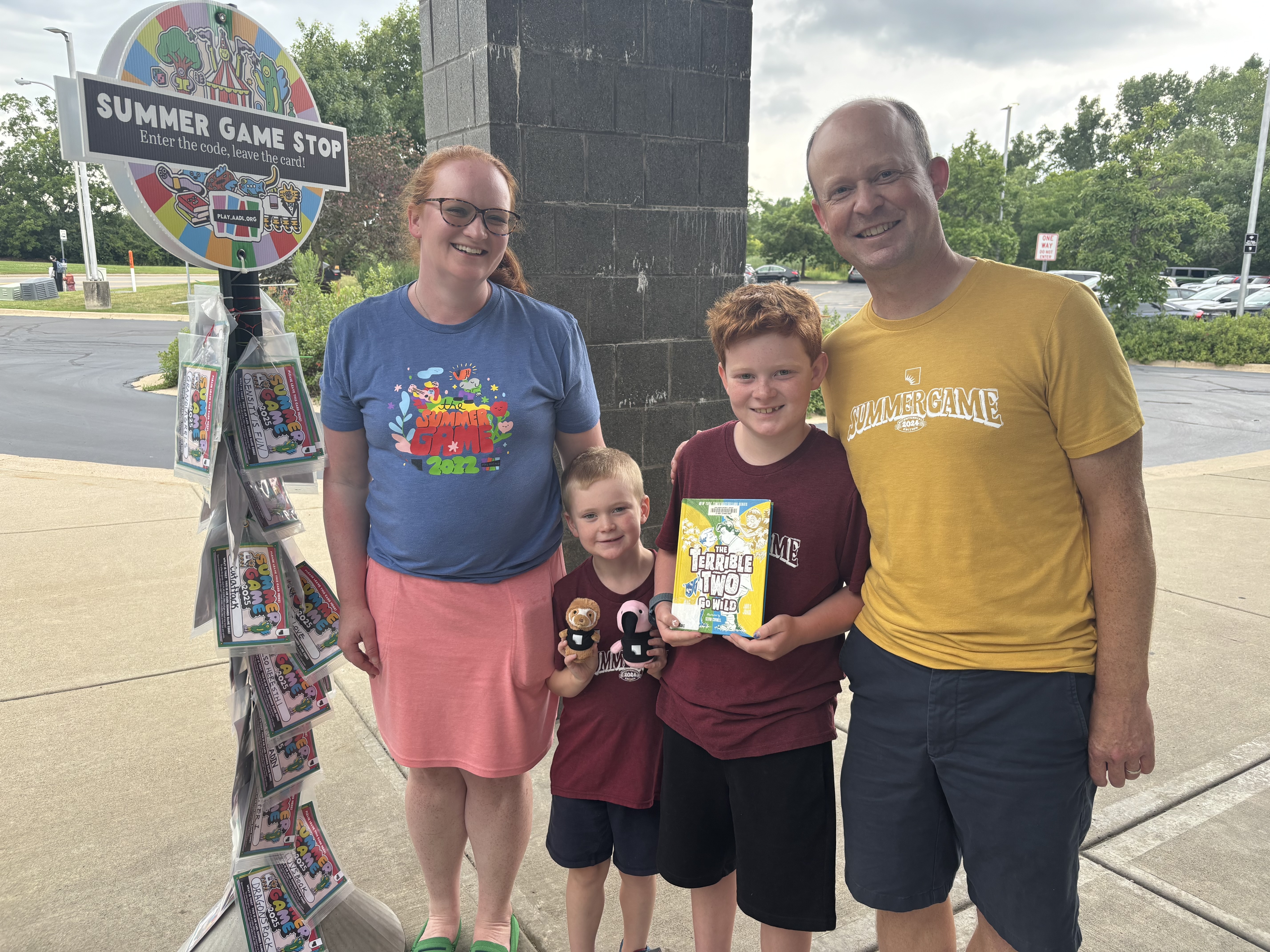 The Hautamaki family (Shannon, left, Ian, Graham and Bret) pose outside the Pittsfield branch of the Ann Arbor District Library, where they collected points for the Summer Game.